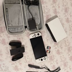OLED switch console with all its accessories and two games