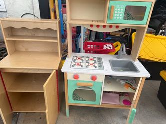 Toy kitchen with wooden storage cabinet