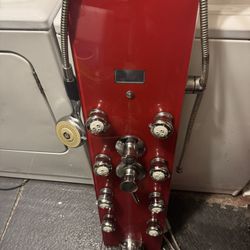 Modern multi-function shower panel with tempered glass front and stainless steel fixtures. Includes overhead rain shower, multiple body jets, handheld