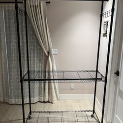 Heavy duty Rolling Clothing Rack with Double Rod. Shelves, hooks On Sides,  and with Lockable Wheels. Original price was $129.99. In great condition. 