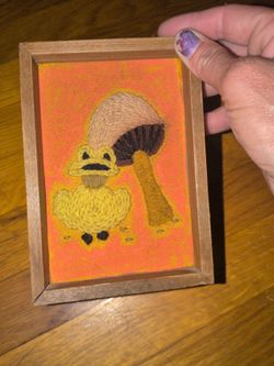 vintage 1970s handmade crewel embroidery art picture featuring a frog and mushroom