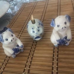 A group of 3 pigs. Porcelain salt and pepper shaker and toothpick holder