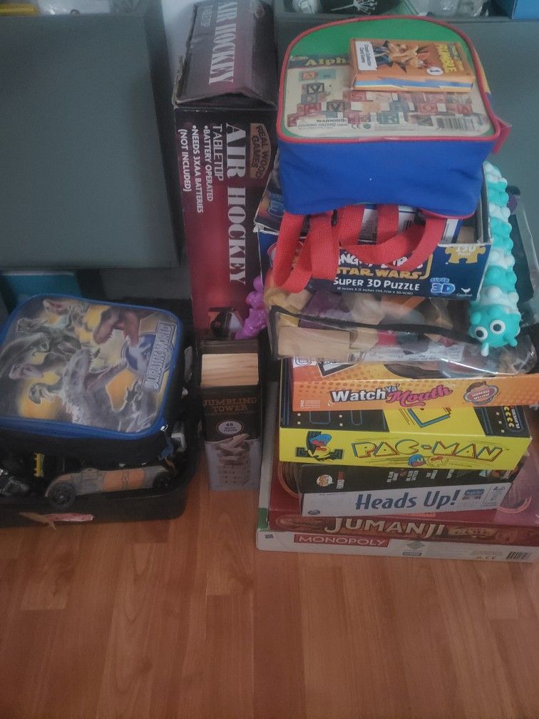 A Bunch Of Board Games And Hot Wheels