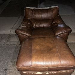brown chair with a ottoman. 