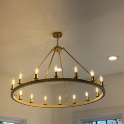 Elegant brass ring chandelier featuring 16 candle-style lights in a timeless halo design.