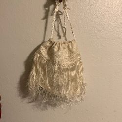 Small, cream-colored, crocheted pouch 