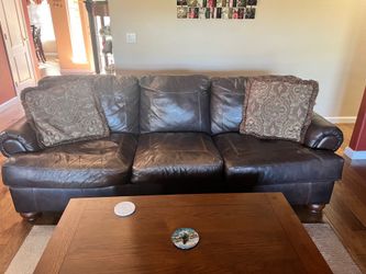 Leather sofa, two oversized chairs with ottomans.