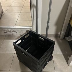 black plastic folding utility cart or shopping trolley.  It