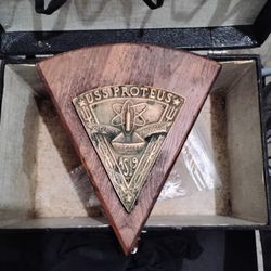 vintage wood and metal plaque featuring the insignia of the USS Proteus (AS-19), a United States Navy submarine tender. 
