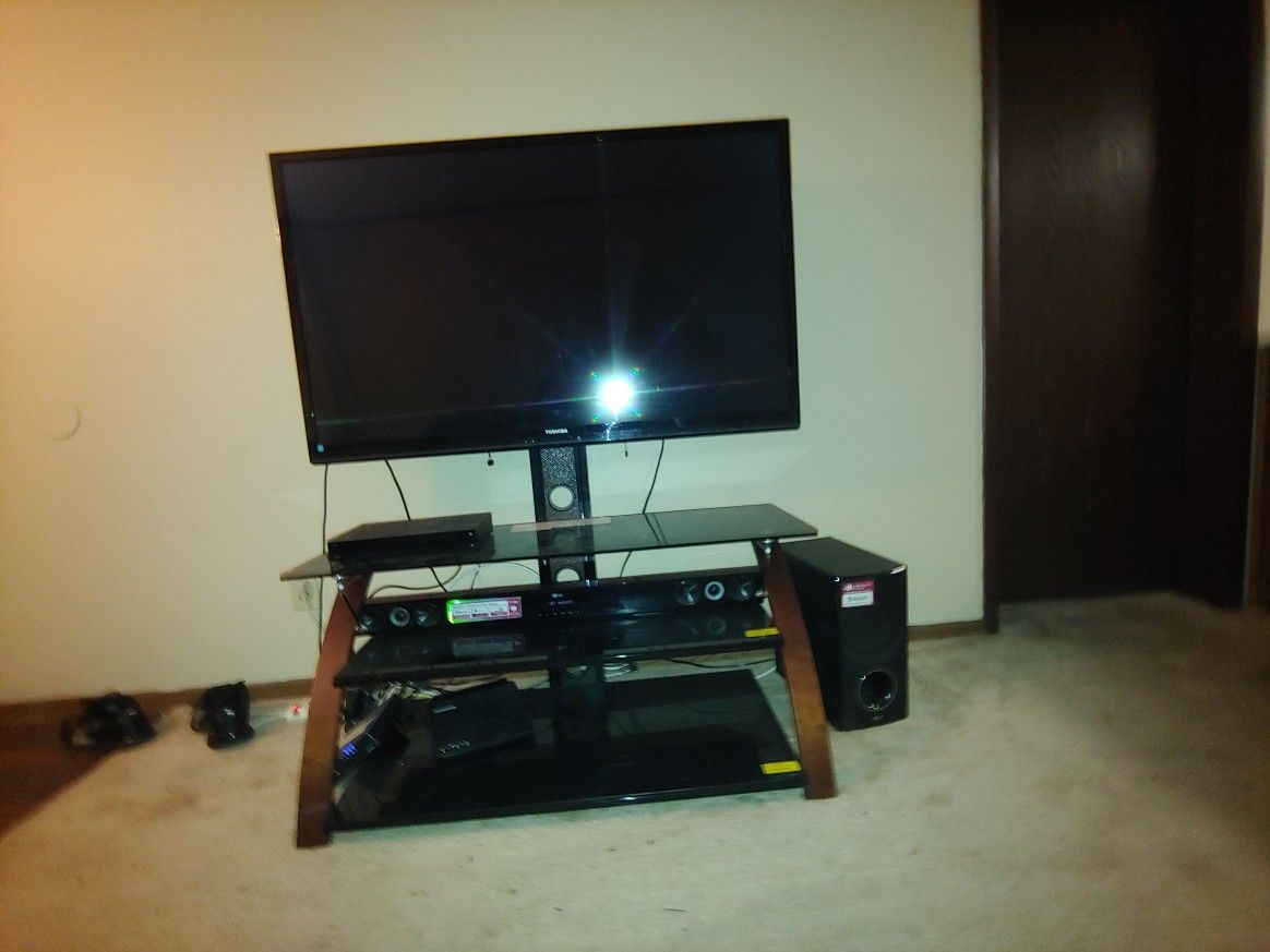 55" Toshiba flat screen with TV stand and LG soundbar and subwoofer