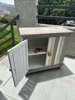 Distressed beachy vibe wood cabinet