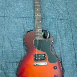 Red Maestro Gilson Electric Guitar With An ACDC Shoulder Strap