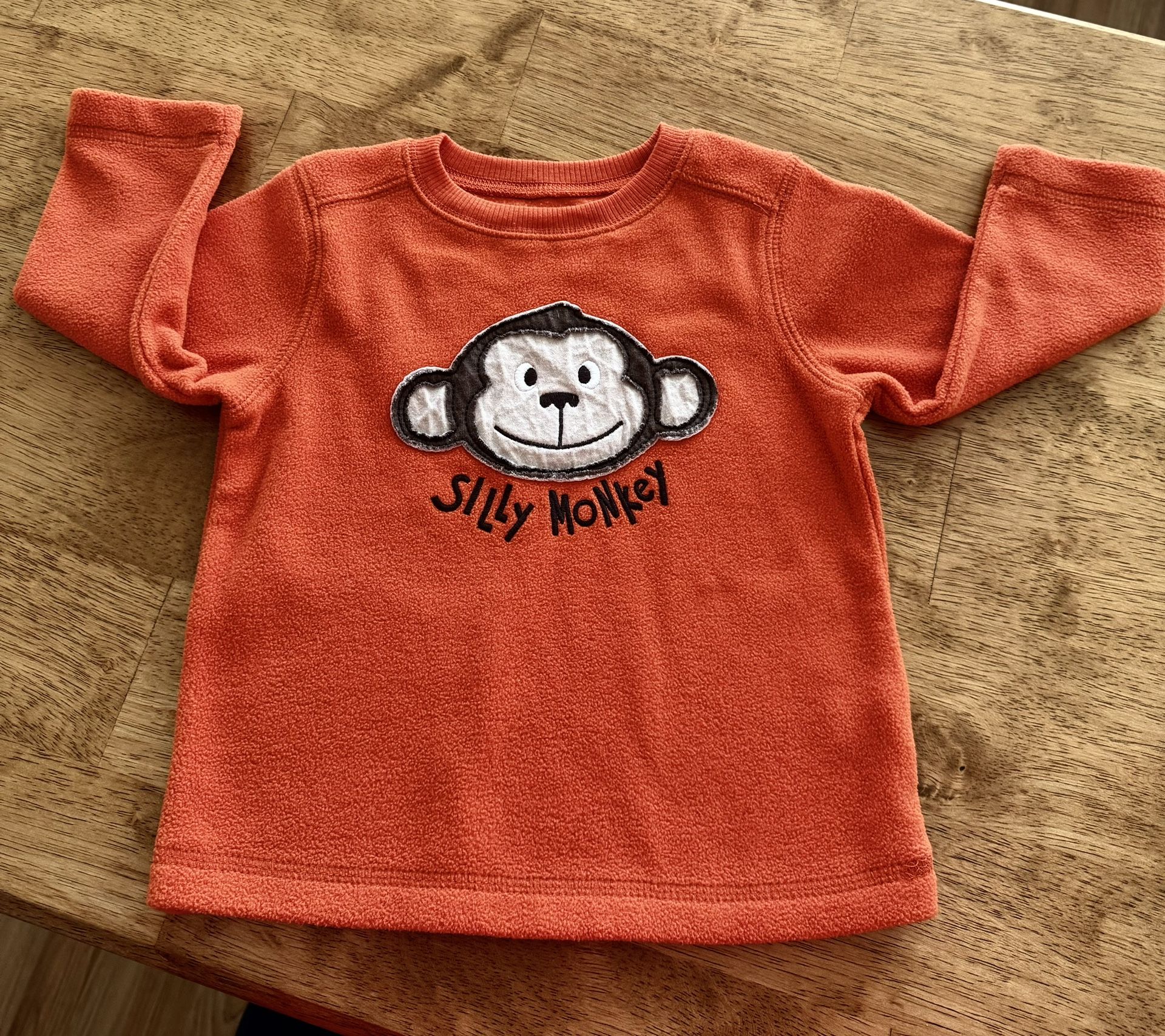 18 mo Cute “Silly Monkey” orange fleece top by Jumping Beans. Good Condition Unisex.