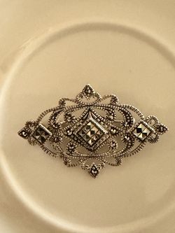 Art Deco marcasite brooch, sterling silver.  Classic diamond-shaped, openwork filigree design