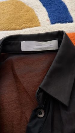 The neckline and chest area are made of genuine leather, while the rest of the fabric is organza.