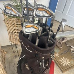 set of Cleveland CG Gold irons stored inside a dark brown Ogio stand or cart golf bag