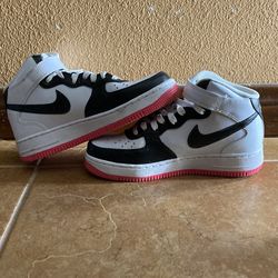 These are Nike Air Force 1 '07 Mid Electric sneakers in a white, black, volt, and hyper pink colorway.