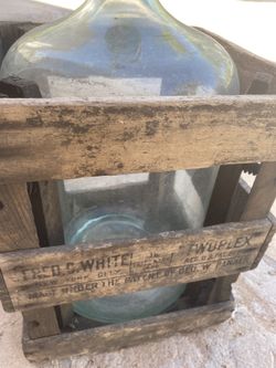Vintage glass bottle in wood frame