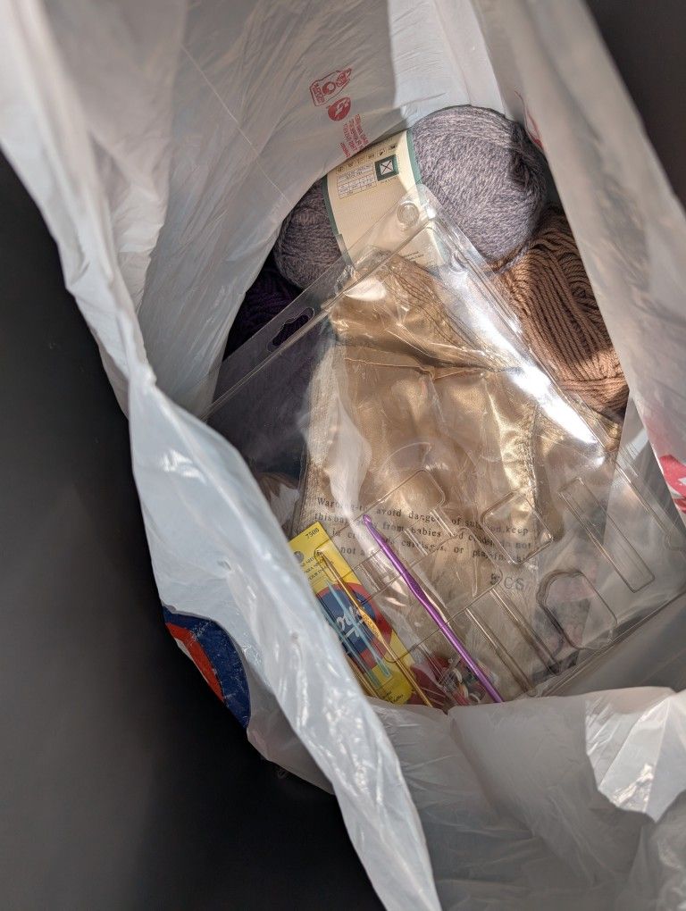 2 Bags Of Yarn And Some Crochet Needles