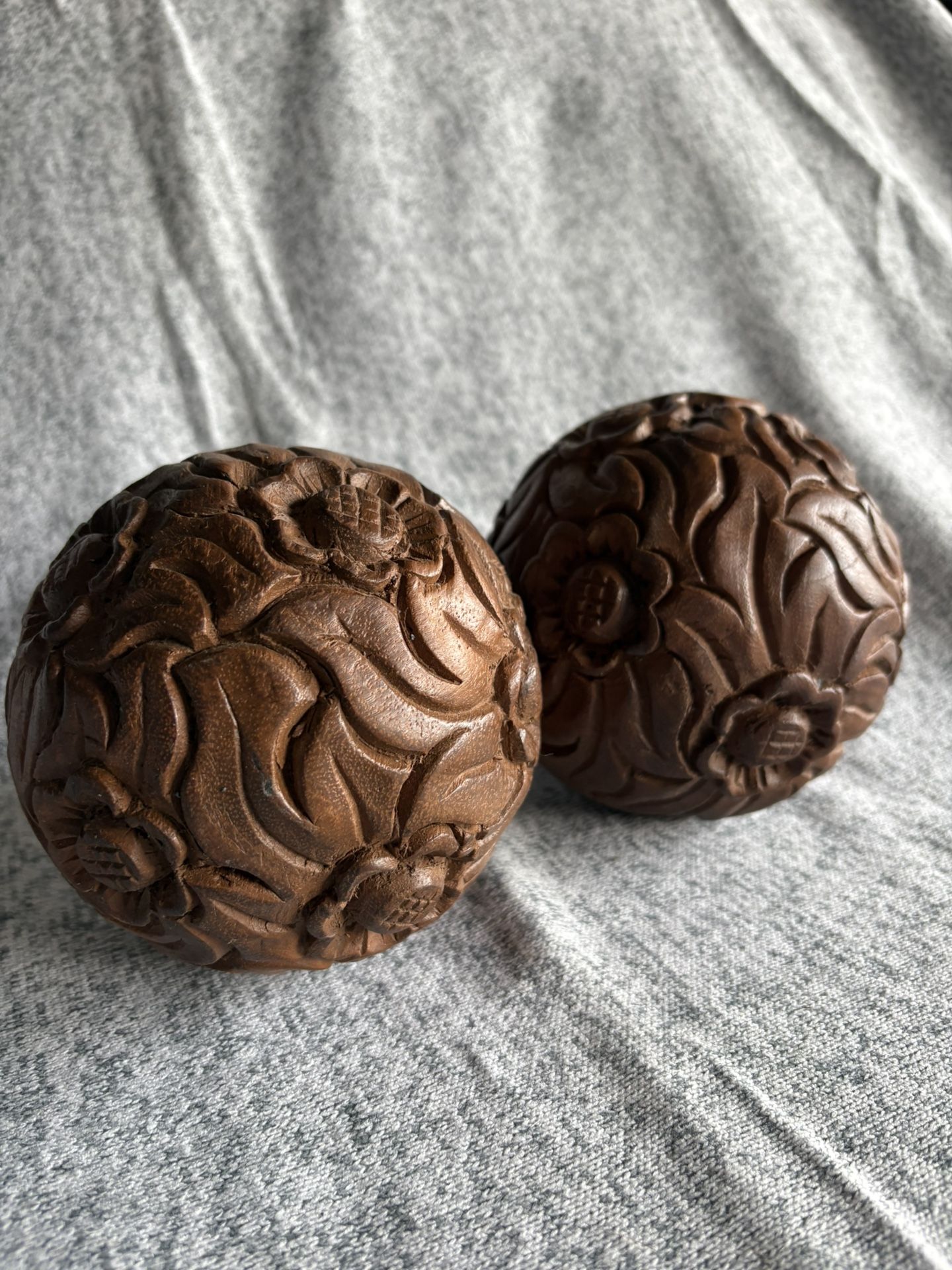 Pair of hand-carved wooden spheres
