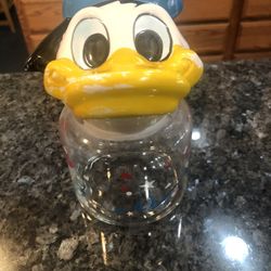 Vintage Disney Donald Duck Canister Jar Red, White and Blue. The lid is Donald Duck head made of Ceramic. Some of the paint is worn off due to age.