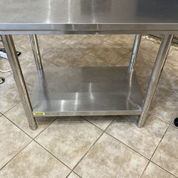 Two stainless steel prep tables.