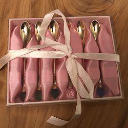 Gold color dessert spoons with colorful stones