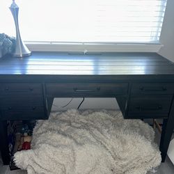 Dark wood desk with outlets
