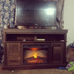 entertainment center with fireplace and smart TV 
