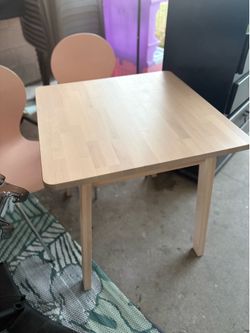 Cute Hard wood table and 2 chairs.  Painted/stained previously.  Great condition.  Table is heavy.  Great for small space
