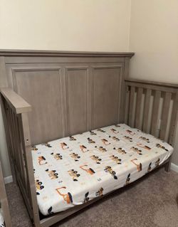 Toddler bed with conversion kit to full size and crib pieces by Oxford Baby