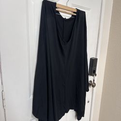 black, V-neck poncho/caftan by The Row.  