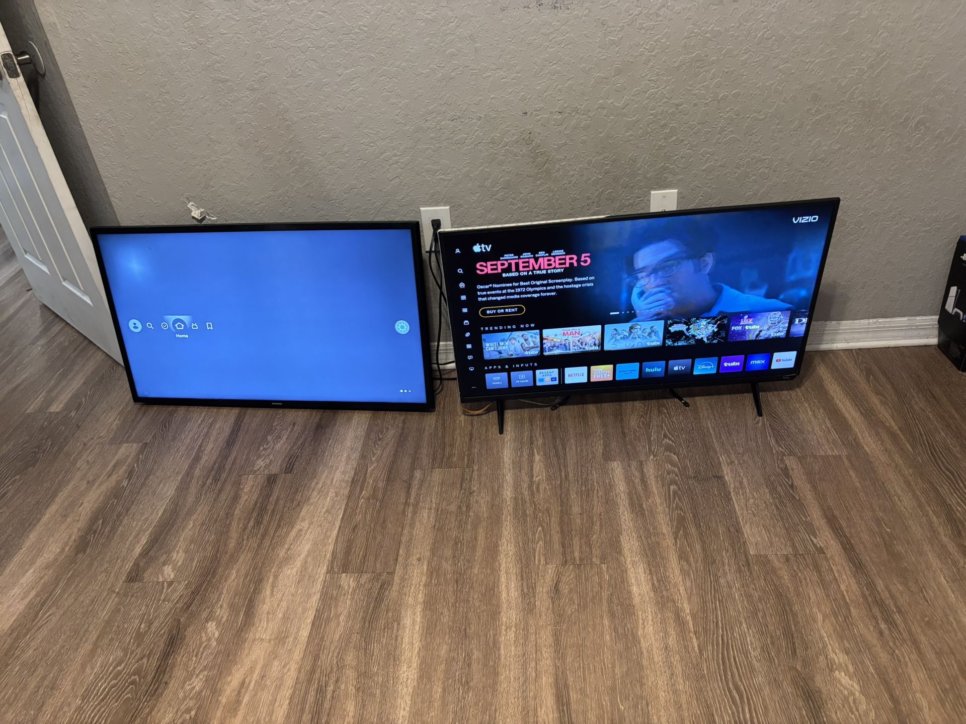 two tvs one apple and the other is an fire stick