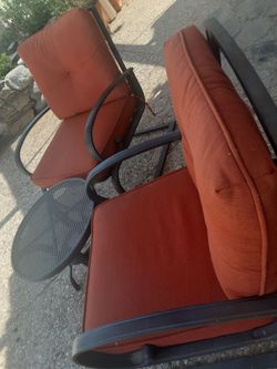 Metal frame set of two patio chairs with cushions and table
