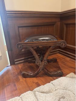 Wood bench with leather seat.