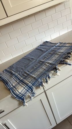Blue and white tablecloth with tassels