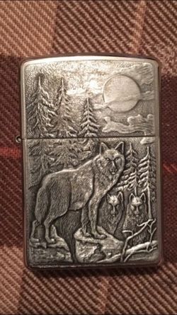 Beautiful zippo with wolves in the forest on the front