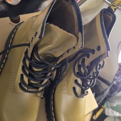 Brown leather boots with black cords.