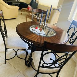 Wood, glass, and wrought iron round table with matching (4) chairs