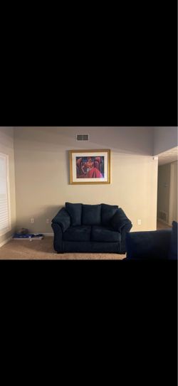 Two lightly used navy blue love seats