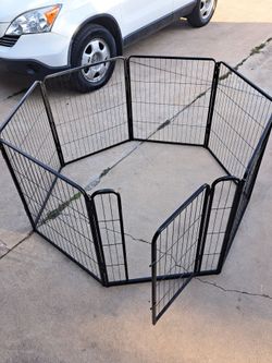 heavy-duty, 7-panel metal folding pet exercise pen and playpen with an integrated access door.