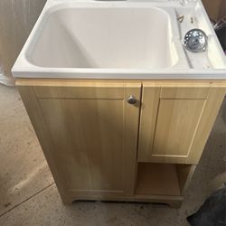 laundry room cabinet with sink and faucet 