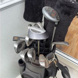 golf clubs and bag with balls