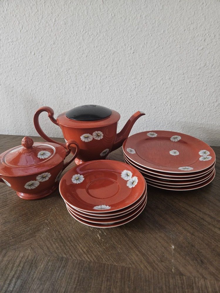 Noritake china tea set, the red brown ground decorated with flowers.