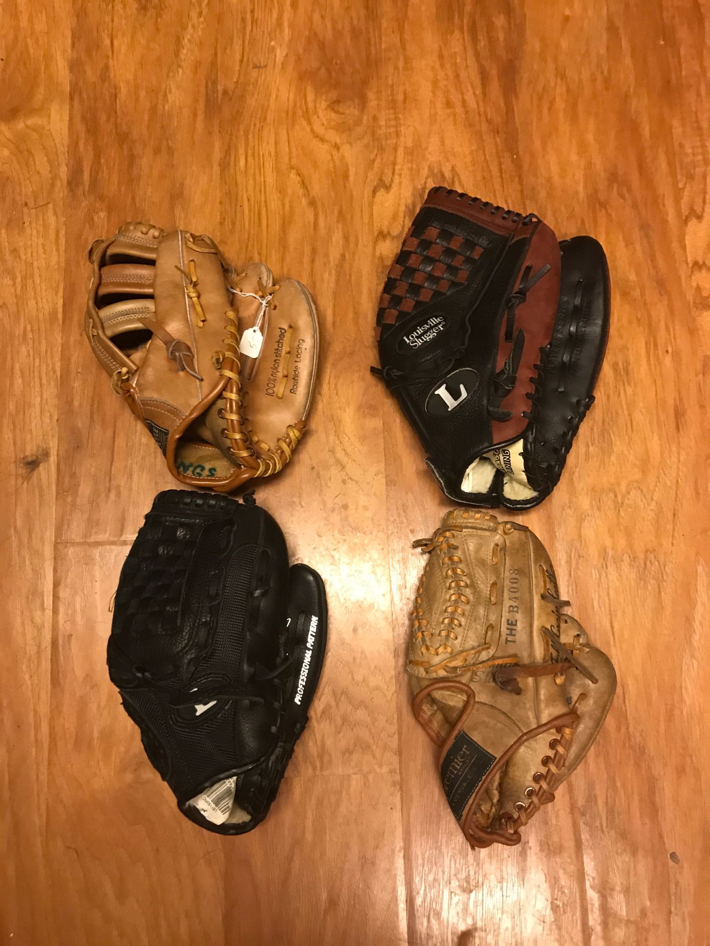 2 Louisville slugger baseball gloves and 2 brown youth gloves 70 takes all 4