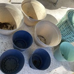 Eight Plant Pots plastic, and one wicker