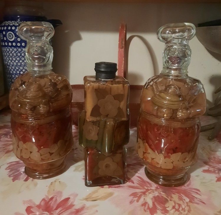SEALED - 3 Bottles Pepper/Spice Infused Oil $50 for All. (The 2 bottles on the sides are 12" Tall & Middle one is 9" Tall)