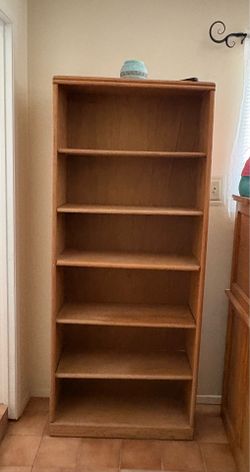Wooden bookcase with adjustable shelves. 6 ‘ tall x 2 1/2 “ wide x 1 ‘ deep
