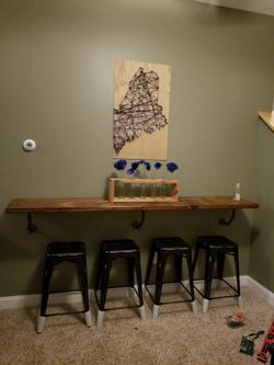 four black metal stools