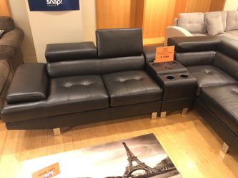 Black leather sectional sofa with Bluetooth speaker console